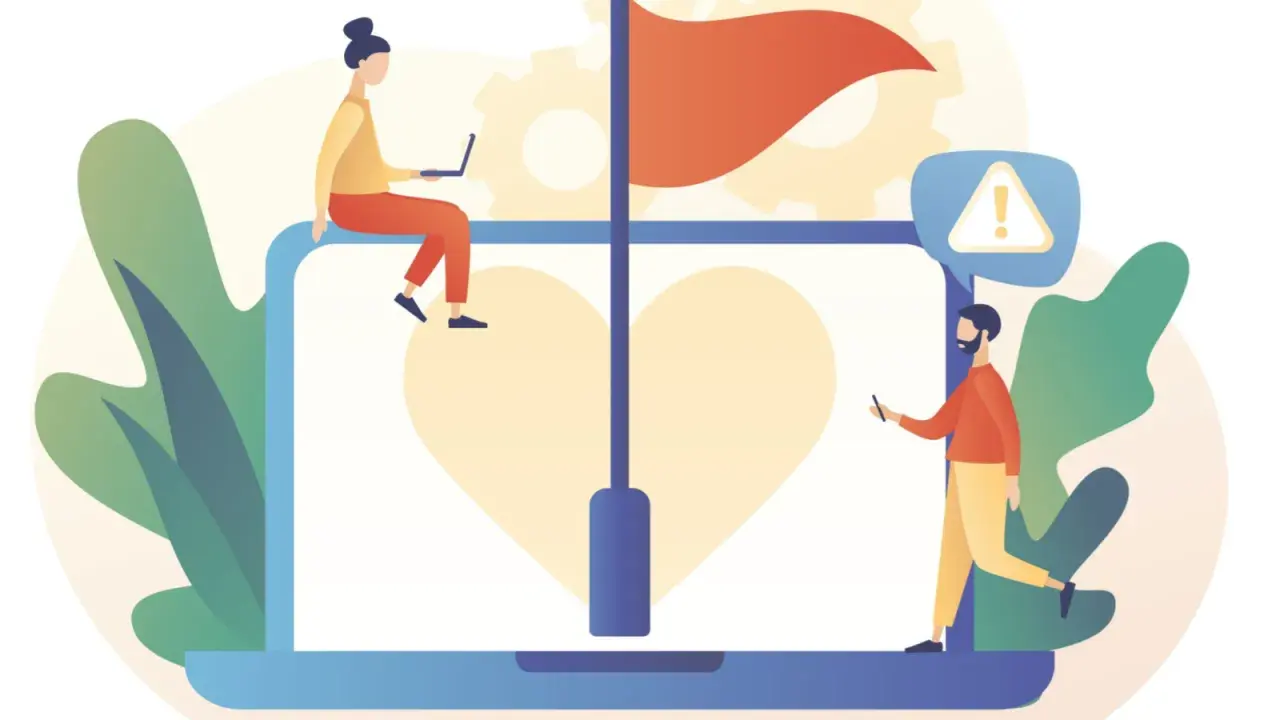Persone analizzano cosa sono le red flags di una persona su un laptop con un cuore e una bandiera rossa.