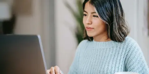 Ragazza concentrata al computer, forse sta usando il chat Tiscali per lavoro o svago.