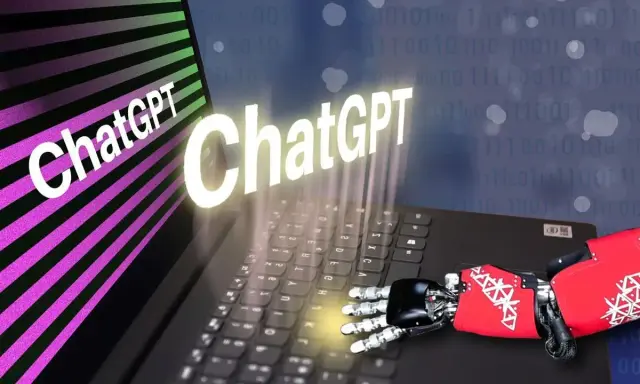 Un braccio robotico interagisce con un laptop, mostrando il logo ChatGPT. Un'immagine che evoca il futuro del chat random Italia.